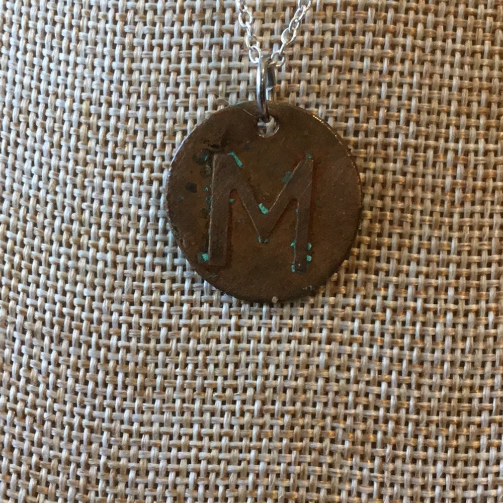 Etched copper “M” pendant.